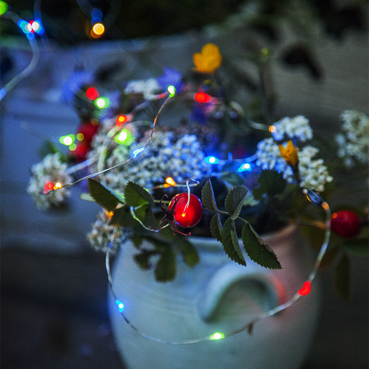 Solar-powered string lights with coloured lamps