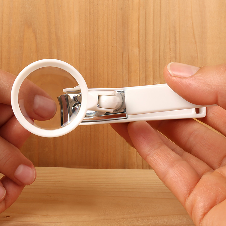 Nail clipper with magnifying glass & collector