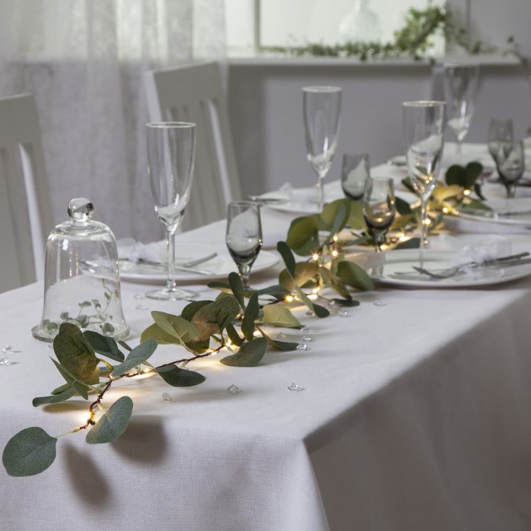 Battery-powered string lights with eucalyptus leaves