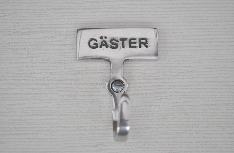 Hook with sign, GÄSTER, Exmez, Sand-cast aluminum