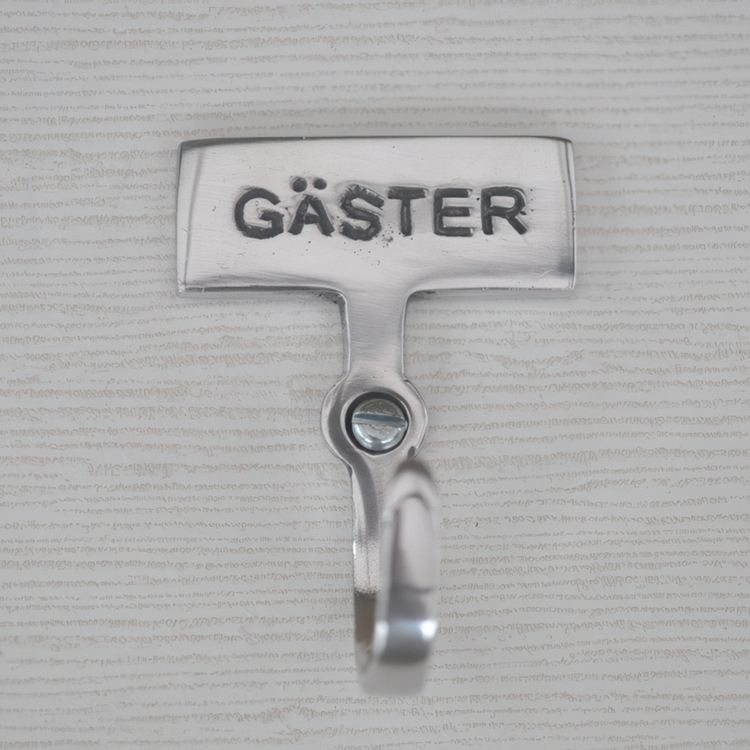 Hook with sign, GÄSTER, Exmez, Sand-cast aluminum