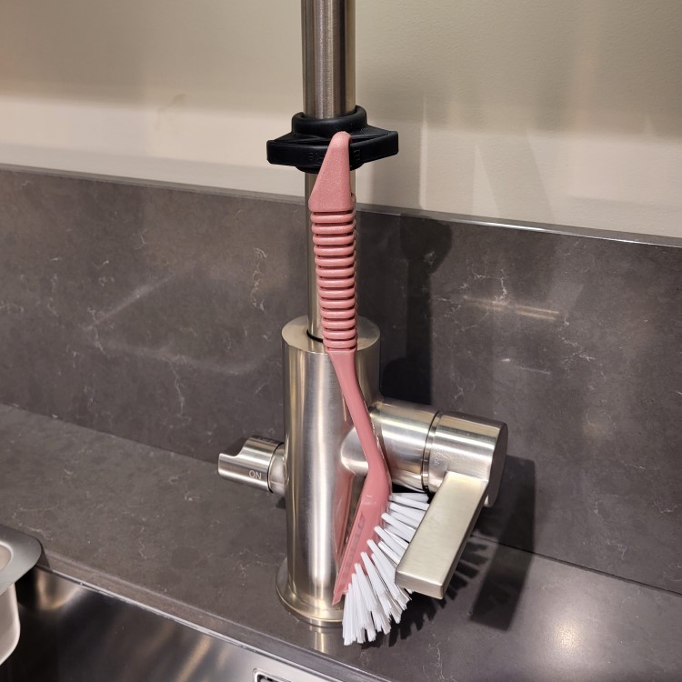 Washing up brush holder for the tap