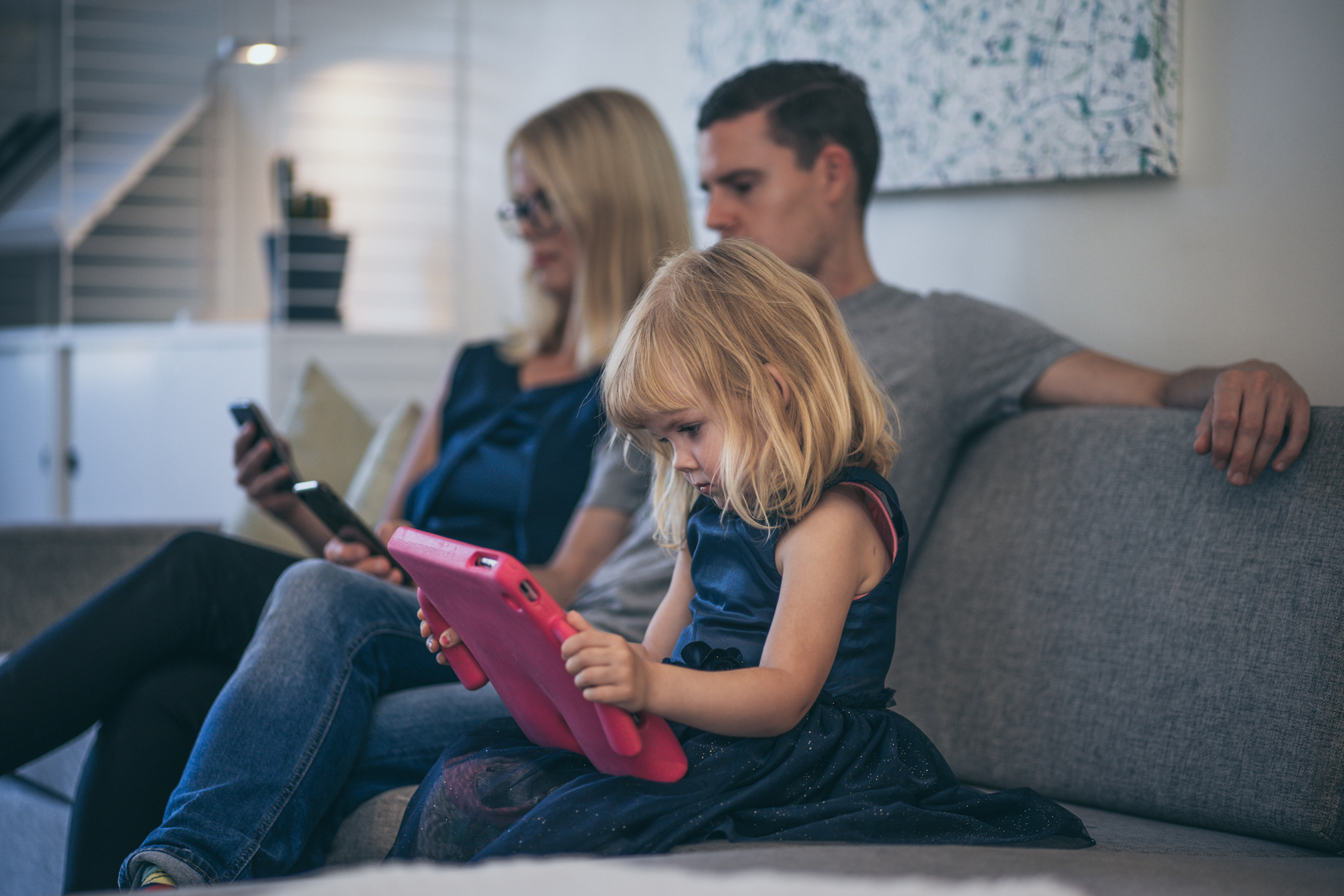 Family with phones and iPad