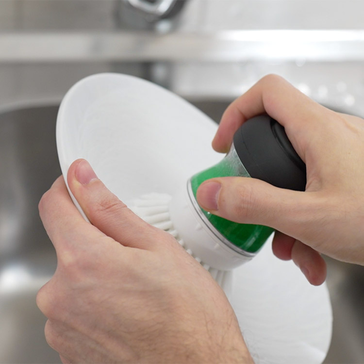 Handheld washing-up brush and washing-up liquid container