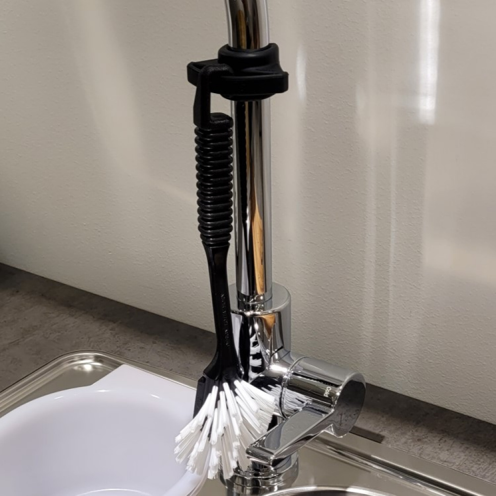 Washing up brush holder for the tap